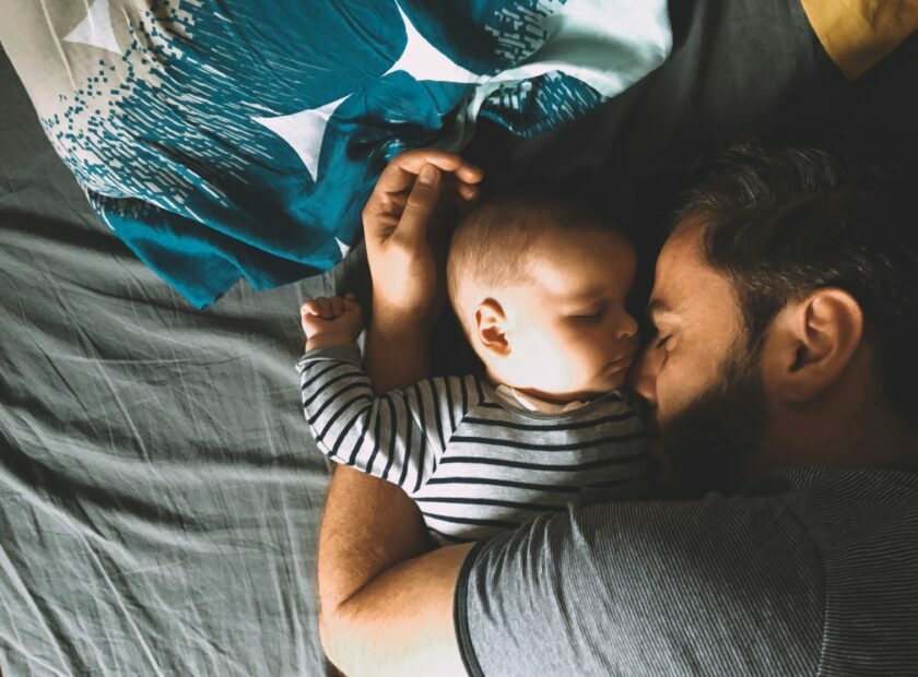 Father and son sleeping in bed